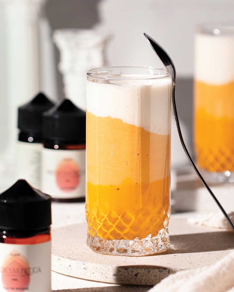 Candy Corn Inspired Smoothie with spoon and bottles of flavour